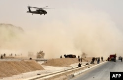 A U.S. Black Hawk helicopter flies over the site of a Taliban suicide attack in Kandahar, Afghanistan, Aug. 2, 2017.