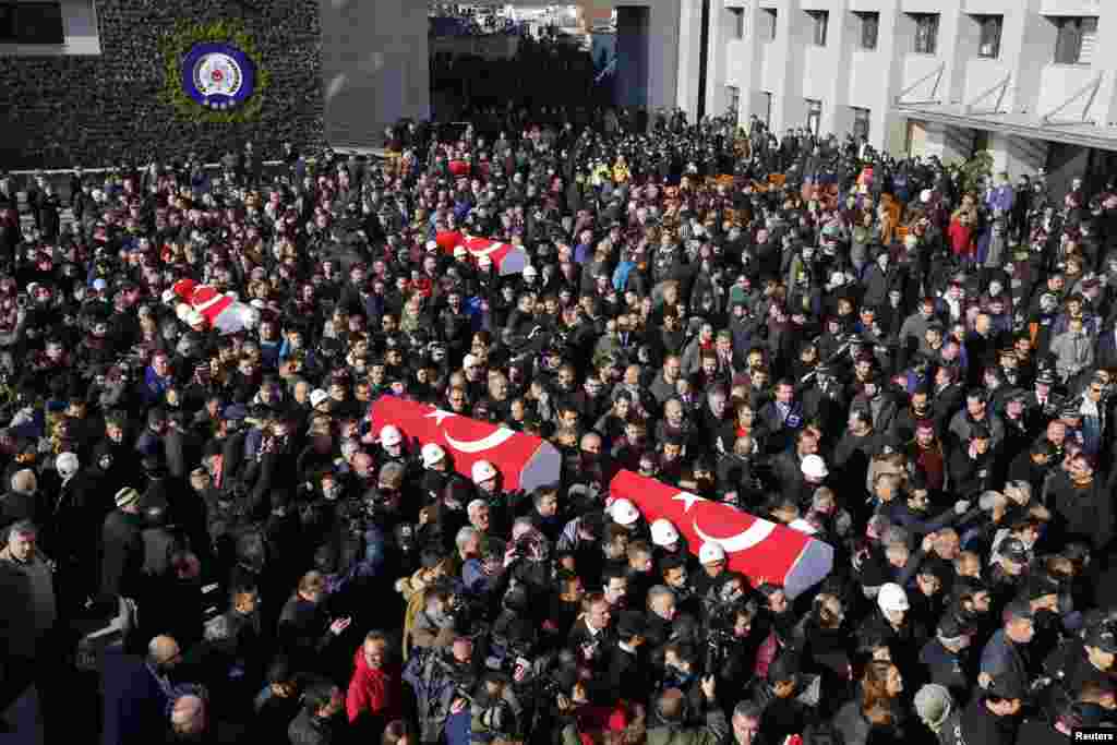 People carry the flag-draped coffins of police officers killed in Saturday&#39;s blasts in Istanbul, Turkey, Dec. 11, 2016.