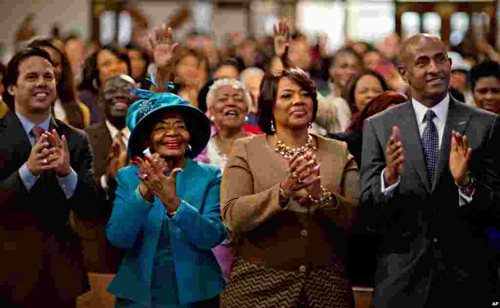 Dr. Bernice King, center right, and Christine King Farris, left, the daughter and sister of Dr. Martin Luther King Jr., applaud while watching a broadcast of President Barack Obama's inauguration following the Dr. Martin Luther King Jr. holiday commemorative service at the Ebenezer Baptist Church in Atlanta, Jan. 21, 2013.