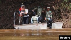 A French rescue team surveys the crash site of an ATR-72 turboprop plane in Pakse, Oct. 19, 2013. 