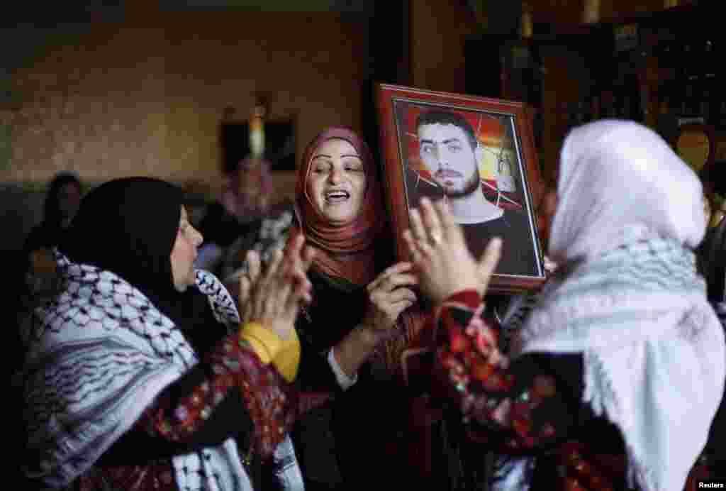 Relatives of Palestinian prisoner Rami Barbakh, who has been held by Israel since 1994, celebrate ahead of his expected release in Khan Younis, Gaza Strip, Dec. 30, 2013.&nbsp;