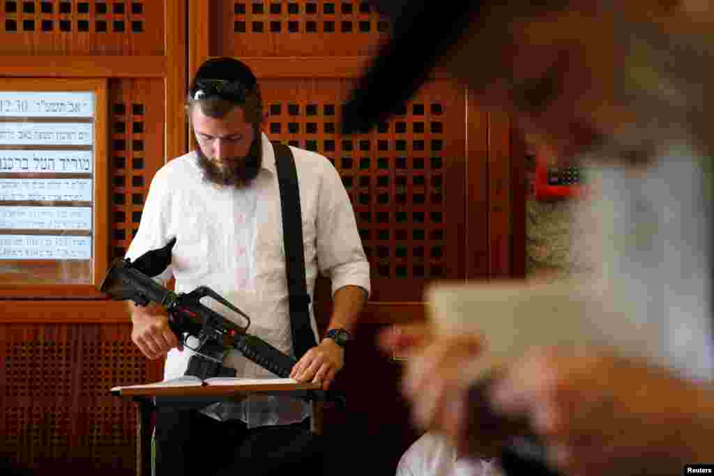 Ultra-Orthodox Jewish worshippers pray at the Western Wall in Jerusalem&#39;s Old City on Tisha B&#39;Av. Tisha B&#39;Av, a day of fasting and lament, commemorates the date in the Jewish calendar on which it is believed that First and Second Temples were destroyed in Jerusalem.