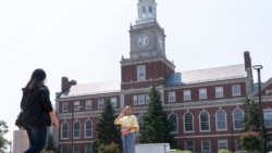 FILE - In this July 6, 2021, file photo with the Founders Library in the background, people walk along the Howard University campus in Washington. (AP Photo/Jacquelyn Martin, File)