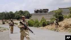 Pakistani army soldiers patrol during a military operation against militants in Pakistan's Khurram tribal region, July 10, 2011