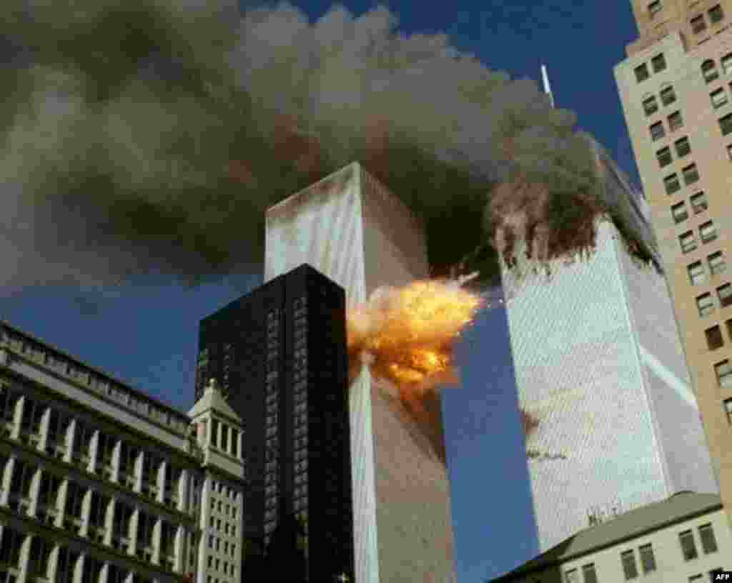 SECOND OF A SERIES OF FOUR PHOTOS---Smoke pours off one of the towers of the World Trade Center as flames explode from the second one as it is struck by a plane Tuesday, Sept. 11, 2001, after terrorists crashed planes into the buildings. The attack colla