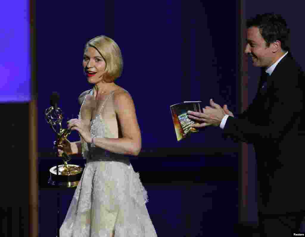 Actress Claire Danes accepts the award for Outstanding Lead Actress In A Drama Series for her role in "Homeland" from presenter Jimmy Fallon at the 65th Primetime Emmy Awards in Los Angeles, Sept. 22, 2013. 