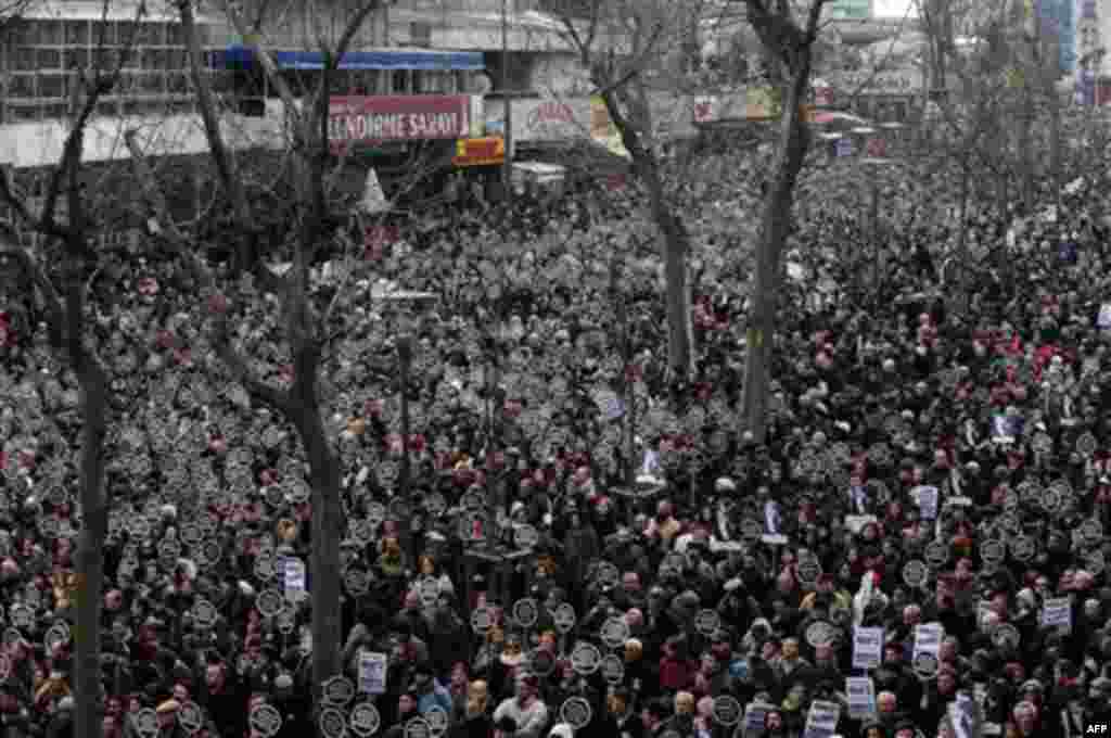 Holding banners that read "We are all Hrant, we are all Armenian.", as some tens of thousands of protesters march to mark the fifth anniversary of Turkish-Armenian journalist Hrant Dink's murder in Istanbul, Turkey, Thursday, Jan. 19, 2012, as outrage con