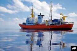 FILE - In this Wednesday, Aug. 23, 2017 file photo, Aquarius the vessel of NGOs, SOS Mediterranee and MSF drifts in the international waters north of Libya. Migrants trying to reach Europe face routine rape and sexual torture throughout their journey _ anFILE - In this Wednesday, Aug. 23, 2017 file photo, Aquarius the vessel of NGOs, SOS Mediterranee and MSF drifts in the international waters north of Libya. Migrants trying to reach Europe face routine rape and sexual torture throughout their journey - and especially in Libya - with men facing abuse nearly as routinely as women, according to a study based on dozens of interviews with aid workers and migrants.