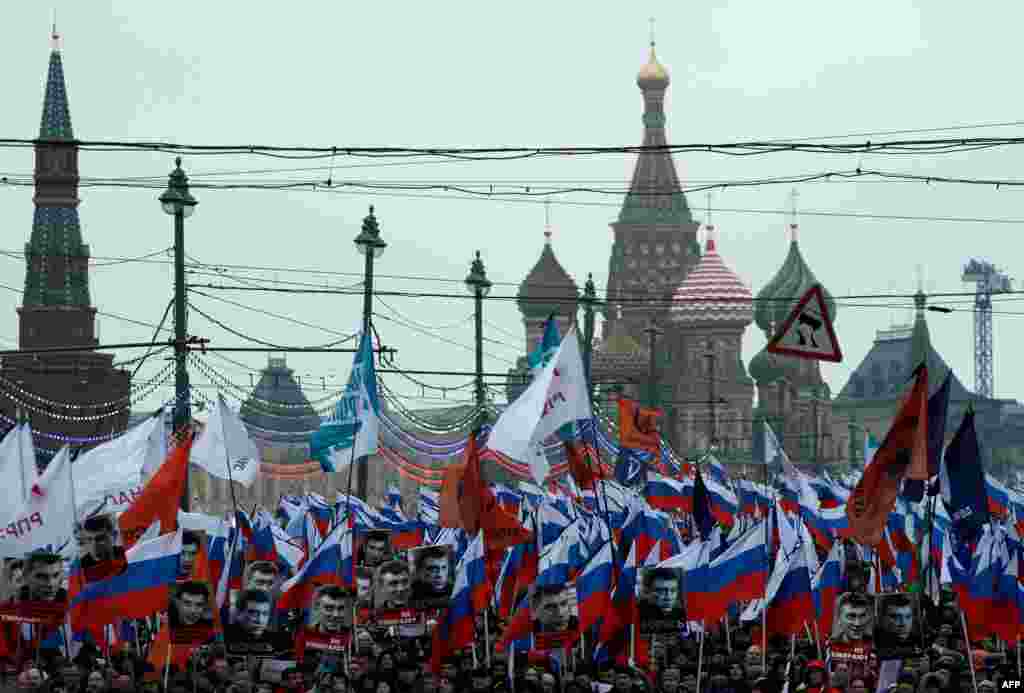 Russia&#39;s opposition supporters march in memory of murdered Kremlin critic Boris Nemtsov in central Moscow . The 55-year-old former first deputy prime minister under Boris Yeltsin was shot in the back several times just before midnight on Feb. 27 as he walked across a bridge a stone&#39;s throw from the Kremlin walls.