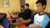 FILE - Cambodian men use the internet at a cofee shop in Phnom Penh.