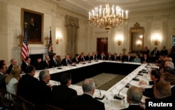 President Donald Trump holds a meeting with manufacturing CEOs in the State Dining Room of the White House in Washington, Feb. 23, 2017.