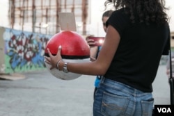 A Pokemon GO fan poses with a replica Pokeball during a gathering organised and backed by a Lebanese tech firm, which hid energy drinks in the Pokeballs.