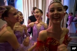 Harper Ortlieb, center, from Mount Hood, Oregon, and her ballet school colleagues congratulate each other after performing at the Bolshoi Ballet Academy in Moscow, March 3, 2016.