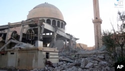 This undated frame grab from video posted online June 10, 2017 by the Aamaq News Agency, a media arm of the Islamic State group, shows a mosque that was damaged by bombardment by the U.S.-led coalition and U.S.-backed fighters in Raqqa. 