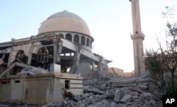 This undated frame grab from video posted online June 10, 2017, by the Aamaq News Agency, a media arm of the Islamic State group, shows a mosque that was damaged by bombardment by the U.S.-led coalition and U.S.-backed fighters in Raqqa.