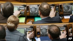 Ukrainian lawmakers vote during a parliament session in Kyiv, Ukraine, Feb. 7, 2019.