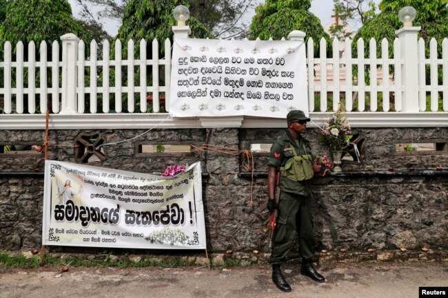 FILE- A soldier stands guard outside St. Sebastian Church, days after a string of suicide bomb attacks across the island on Easter Sunday, in Negombo, Sri Lanka, May 1, 2019.