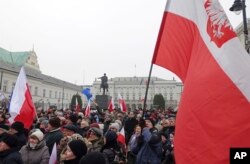 Protesters attend an anti-government demonstration, in Warsaw, Poland, Dec. 17, 2016.