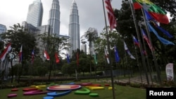 FILE - National flags and the Association of Southeast Asian Nations logo are on display ahead of an ASEAN summit in Kuala Lumpur, Malaysia, Nov. 18, 2015. 