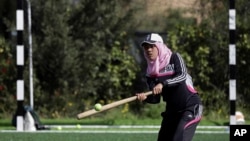Palestinian women train for an all-women's baseball game on a soccer field in Khan Younis, southern Gaza Strip, March 19, 2017.