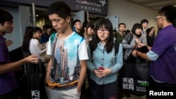 FILE - Students leave after a Scholastic Assessment Test session at AsiaWorld-Expo in Hong Kong Nov. 2, 2013.