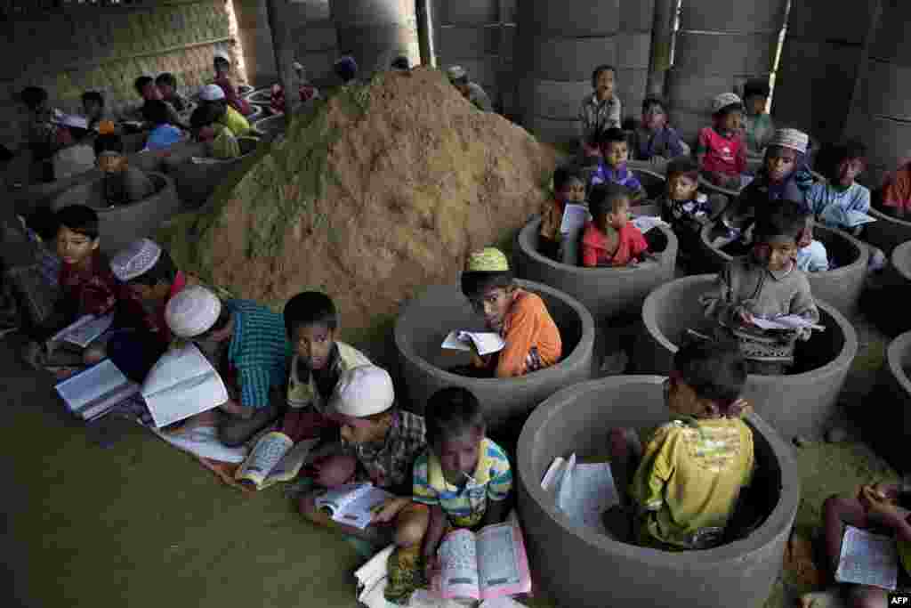Rohingya refugee children attend recitation classes of the holy Quran in a newly opened madrassa, or religious school, in a Balukhali refugee camp, Bangladesh, Oct. 30, 2017.