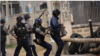 စစ်အာဏာသိမ်းမှု ဆန့်ကျင် ဆန္ဒပြသူတွေကို အကြမ်းဖက်နှိမ်နင်းနေတဲ့ ရဲတပ်ဖွဲ့ဝင်များ။ (မတ် ၁၁၊ ၂၀၁၁)