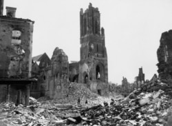 FRANCE -- Among the wreckage of St. Lo, France, on July 31, 1944, now being cleared by U.S. engineers, is the tower of Notre Dame Cathedral almost isolated. Shattered buildings are seen all around - evidence of the fierce fighting between American and Nazi forces.