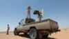 FILE - Libyan forces allied with the U.N.-backed government patrol to prevent Islamic State resurgence on the outskirts of Sirte, Libya, Aug. 4, 2017. 