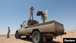 FILE - Libyan forces allied with the U.N.-backed government patrol to prevent Islamic State resurgence on the outskirts of Sirte, Libya, Aug. 4, 2017. 