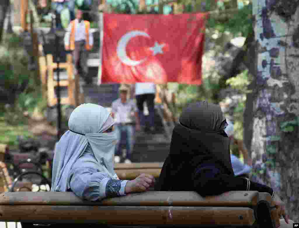 Women sit in Kugulu Park where dozens of Turkish youths continue their protest, in Ankara. Daily life is partly back to normal in Istanbul and the Turkish capital, after nearly three weeks of protests that were sparked by a violent police crackdown on peaceful activists on May 31.