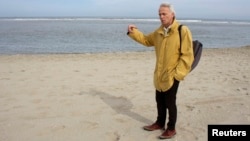 FILE - Jasper Fiselier, an environmental planning expert at Dutch engineering consultants Royal HaskoningDHV, stands on a beach at Ter Heijde, the Netherlands.