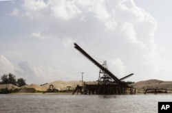 This Aug. 2, 2011 photo shows a sand depot just outside the provincial capital of Koh Kong in southwestern Cambodia. It is owned by Ly Yong Phat, one of the country's biggest tycoons who is being criticized for the environmental damage his sand mining operations inflict on the Cambodian coast. Most of the sand is destined for Singapore. (AP Photo/Heng Sinith)