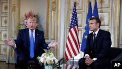 President Donald Trump and French President Emmanuel Macron meet in Caen, France, June 6, 2019.