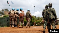 FILE - U.N. peacekeepers and members of the Congolese army in Mavivi, near Beni, North Kivu province, Oct. 22, 2014. Thirty North Korean military instructors may have violated U.N. sanctions by providing pistols to Congolese army and police officers, the United Nations said in a new report.