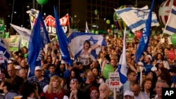 People shout slogans during a rally in Tel Aviv's Rabin Square, calling for Prime Minister Benjamin Netanyahu to be replaced in upcoming national elections, March 7, 2015. 