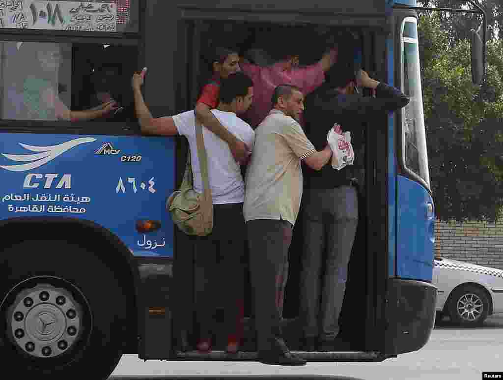 A public bus crammed with commuters is seen on the outskirts of Cairo, Egypt.