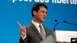 FILE - French Prime Minister Manuel Valls, pictured at a Paris news conference in March, has urged left-wingers to back mainstream right-wingers in regions where National Front candidates can win Sunday.