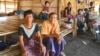 Saw Maung Care (left) and other displaced Kayin sit in shelters at Myaing Gyi Ngu camp, northern Kayin State. (P. Vrieze/VOA) 