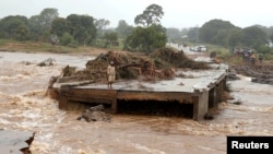 A man looks at a washed away bridge along Umvumvu river following Cyclone Idai in Chimanimani, Zimbabwe, March 18, 2019. 