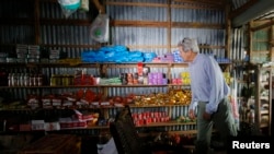 U.S. Secretary of State John Kerry visits a shop along the Mekong River Delta, Vietnam, Dec. 15, 2013. 