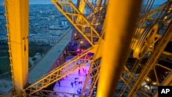 People skate on the ice rink set at 57 meters (188 feet) above the ground on the Eiffel Tower in Paris. Tourism to Paris is showing signs of revival after a yearlong slump attributed to deadly extremist attacks, violent labor protests, strikes and floods, according to figures released Tuesday Feb. 19, 2017. 