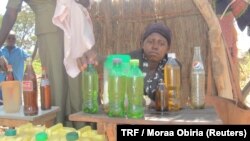 Mary Alinga at her cooking oil shop kit in Arubela, Uganda, Feb. 14, 2018.