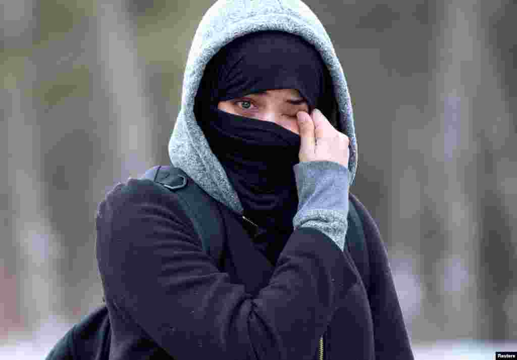 A woman claiming to be from Yemen wipes tears from her eyes as she is told by Canadian police not to enter the U.S.-Canada border into Hemmingford, Quebec, Canada, Feb. 22, 2017.