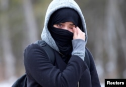 A woman claiming to be from Yemen wipes tears from her eyes as she is told by Canadian police not to enter the U.S.-Canada border into Hemmingford, Quebec Canada February 22, 2017.