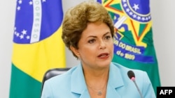 FILE - A handout picture released by the Brazilian presidency's press office shows President Dilma Rousseff during a meeting with representatives of Trade Unions at the Planalto Palace in Brasilia, April 30, 2015. 