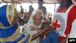 FILE - Yaouba Hamadou, center, a 13-year-old Central African Republic refugee, cries in the arms of relatives as he arrives in Lolo, east Cameroon, April 21, 2017.