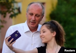 Muharrem Ince, presidential candidate of Turkey's main opposition Republican People's Party (CHP), poses for a selfie with a supporter of him in Elmalik village in Yalova province, Turkey, June 14, 2018.