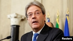 Italy's Foreign Minister Paolo Gentiloni talks to reporters after receiving a mandate to try to form the country's new government, at the Quirinal Palace in Rome, Dec. 11, 2016. 