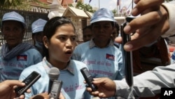 Cambodian protester Tep Vanny, center, talks with journalists after she and a group of others from Beung Kak lake submitted a petition to the National Assembly asking the government to return the title of their land, in Phnom Penh, Cambodia, Wednesday, May 2, 2012. (AP Photo/Heng Sinith)